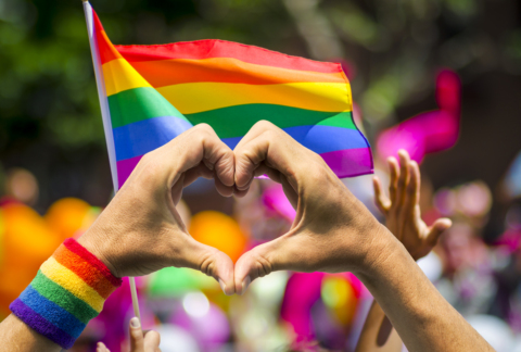 Hands making heart symbol at gay pride parade
